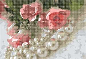 Pearls surround roses on a lace background. A feminine touch.