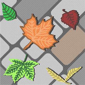 Fallen leaves of varying autumn colors lying on the cobblestone street.