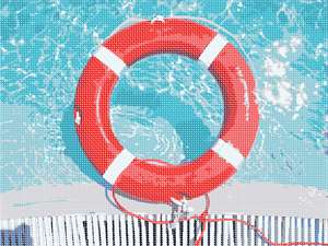 Glistening water with a lifesaver at the edge. Sharp and vivid contrast as the water comes to life.